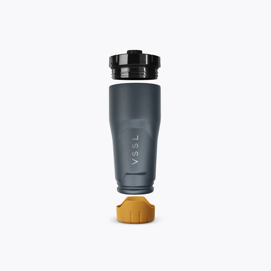 Dark gray water bottle with black cap and yellow base on a white background