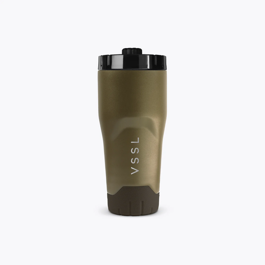 A matte olive green insulated travel tumbler with a black lid and a dark brown textured base, featuring the vertical white text &