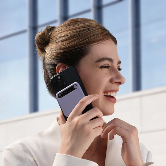 Woman talking on a phone with a modern building in the background