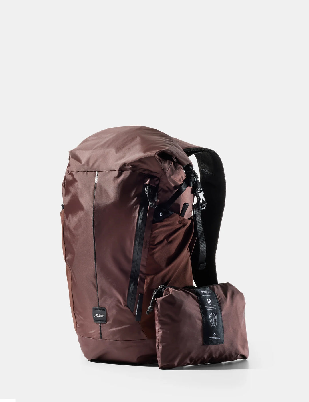 Brown backpack with a smaller pack attached on a white background
