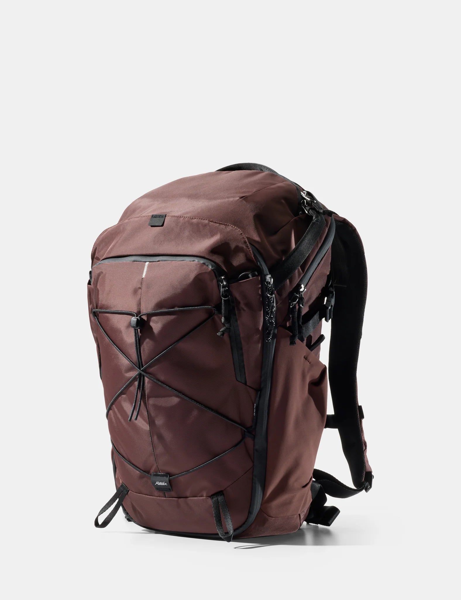 A black Matador 24L Adventure Pack backpack shown from a three-quarter angle on a light gray background, with the Matador logo at the top and '24L Adventure Pack' text at the bottom.