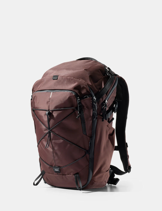 Brown backpack with black straps on a white background