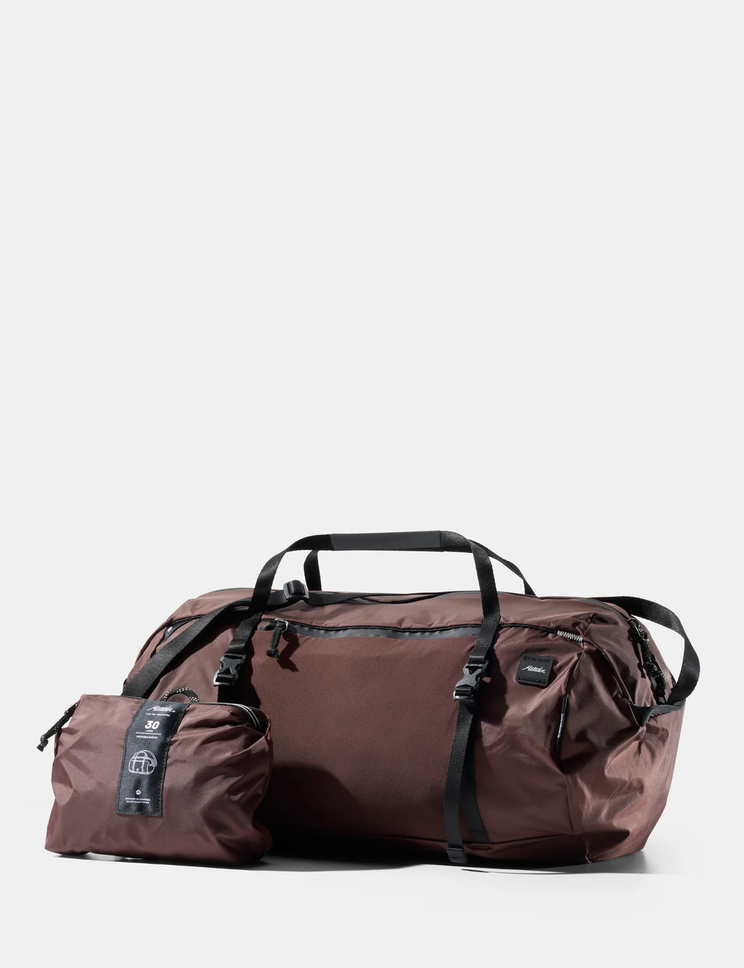 Brown duffel bag with a smaller pouch on a white background