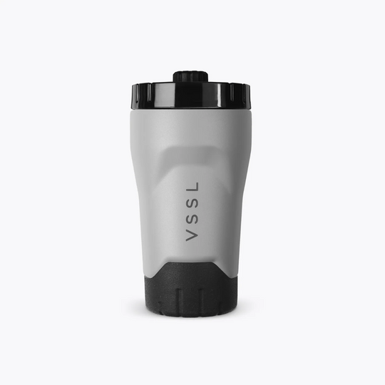 Gray tumbler with black lid and bottom on a white background