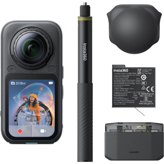 Insta360 action camera shown with included accessories on a clean white background: a black handheld gimbal camera with a front lens and color display screen, a black selfie stick, a black protective lens hood, a black battery with printed specs, and a black charging dock. The Insta360 brand is visible on the camera, stick, battery, and dock.