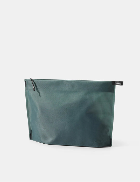 A dark teal waterproof zip pouch with a textured grid pattern, shown from a three-quarter angle on a light gray background. A small black brand tab for &
