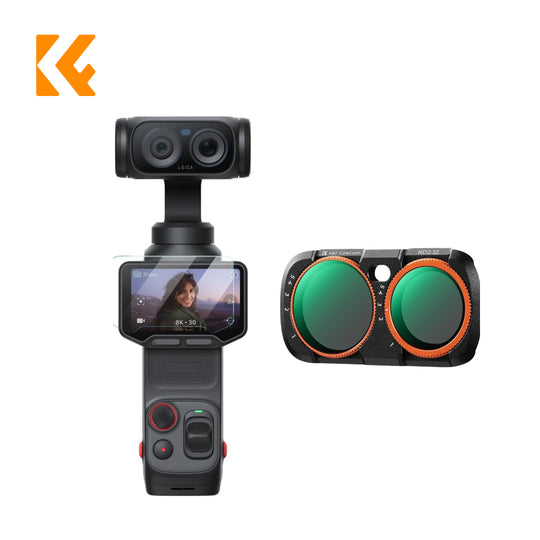 A handheld gimbal camera shown from the front with a screen visible, alongside a separate front view of the gimbal head showing two green circular lens elements with orange rings. The gimbal body is black with small red accents, and an orange logo appears in the top-left corner on a white background.