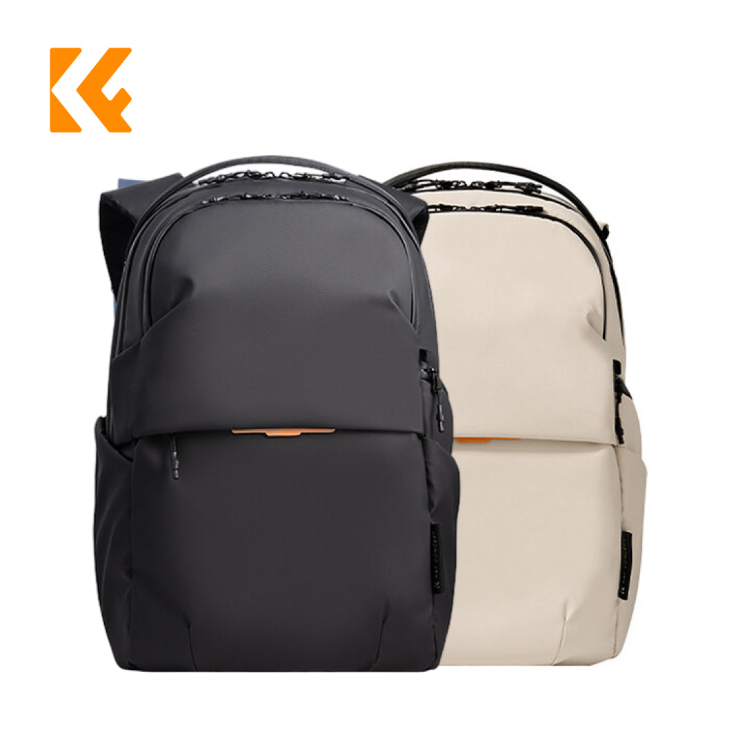 Two backpacks shown on a plain white background: one black in front and one light beige behind it. Both are backpacks with a matte finish, top handles, side pockets, and a small orange accent near the front.