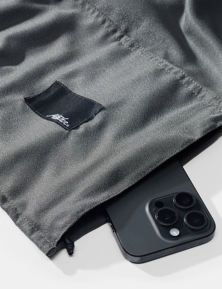 Black phone case with Nike logo on a gray fabric background