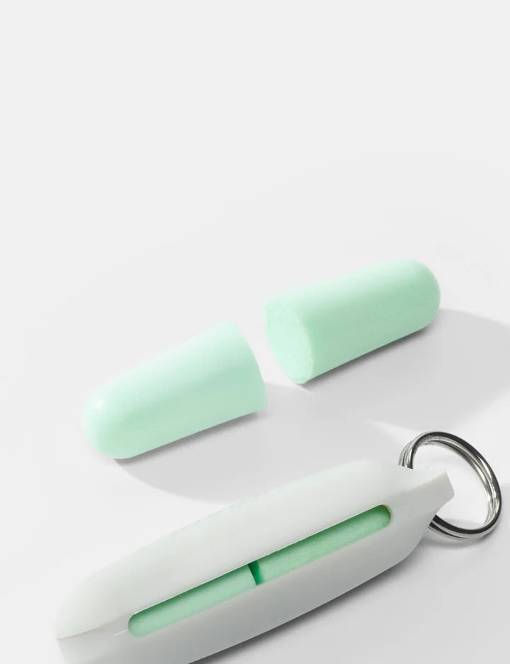 A mint green and white personal safety keychain tool shown open, with two matching mint green cylindrical pieces placed behind it on a clean white background.