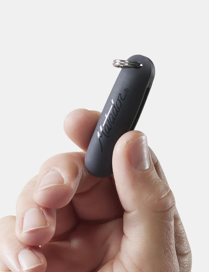 Hand holding a black keychain device with 'Nimble' branding on a light gray background
