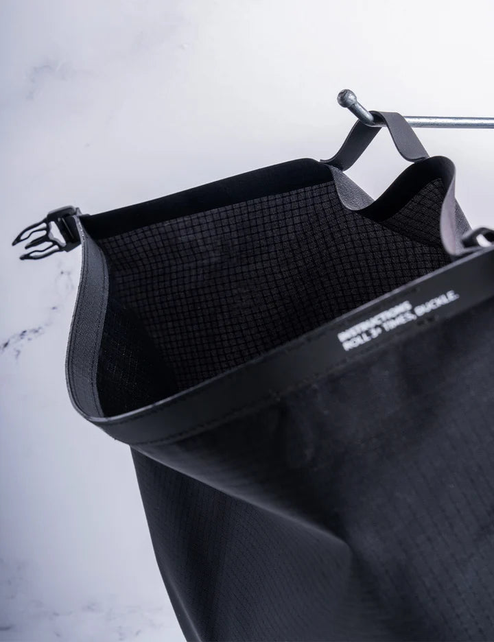 Black pet carrier with grid pattern on a light gray background