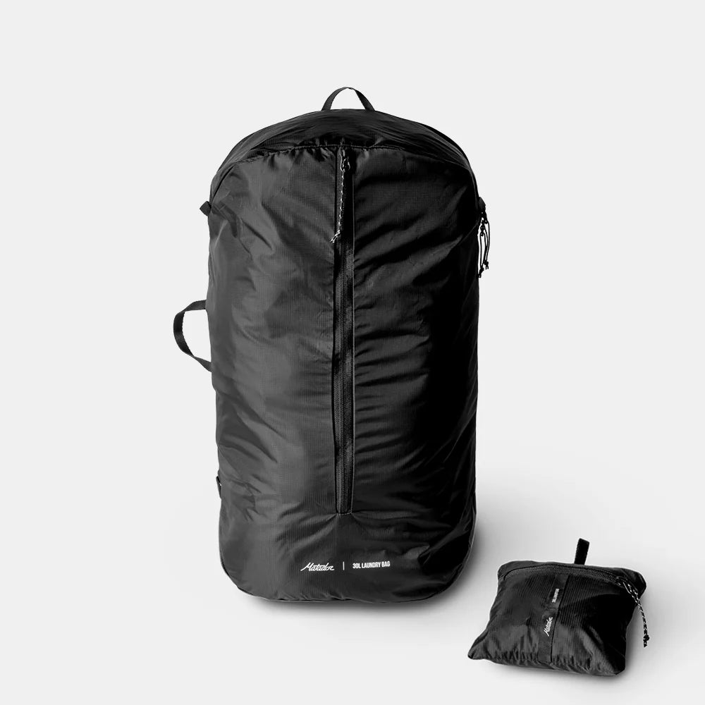 Black Packable Laundry Bag and its compact version on a light gray background
