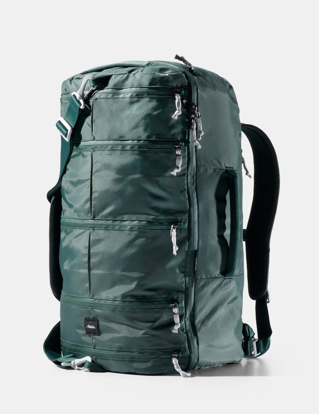 Green backpack with multiple zippers on a white background