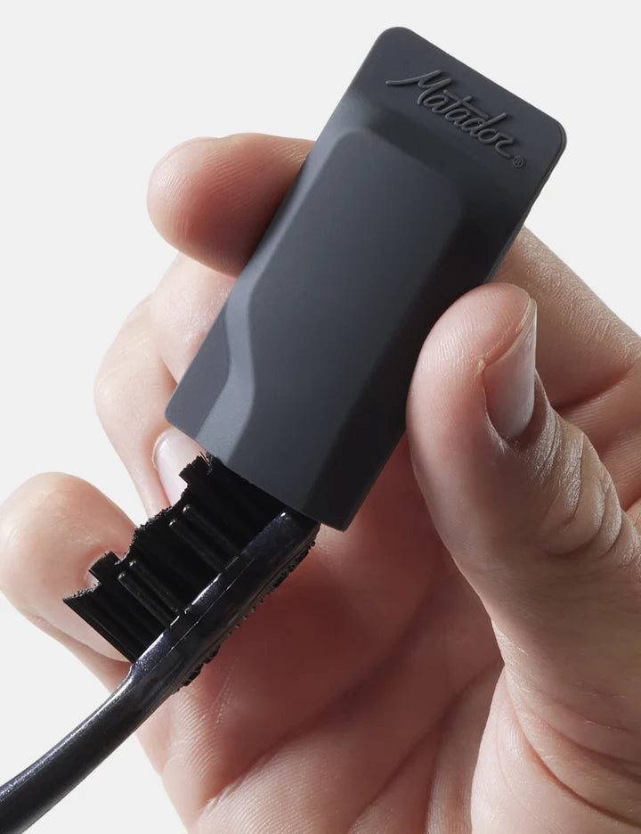 Hand holding a black electronic device with 'Makibes' branding on a white background