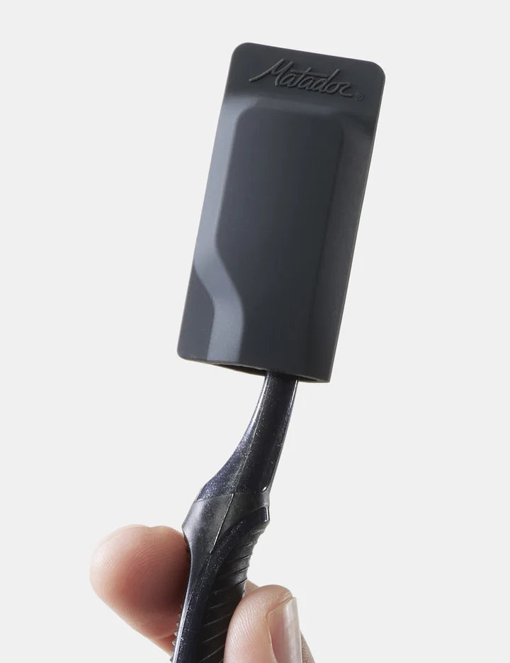 Black spatula with 'Natulure' branding held by a hand against a white background