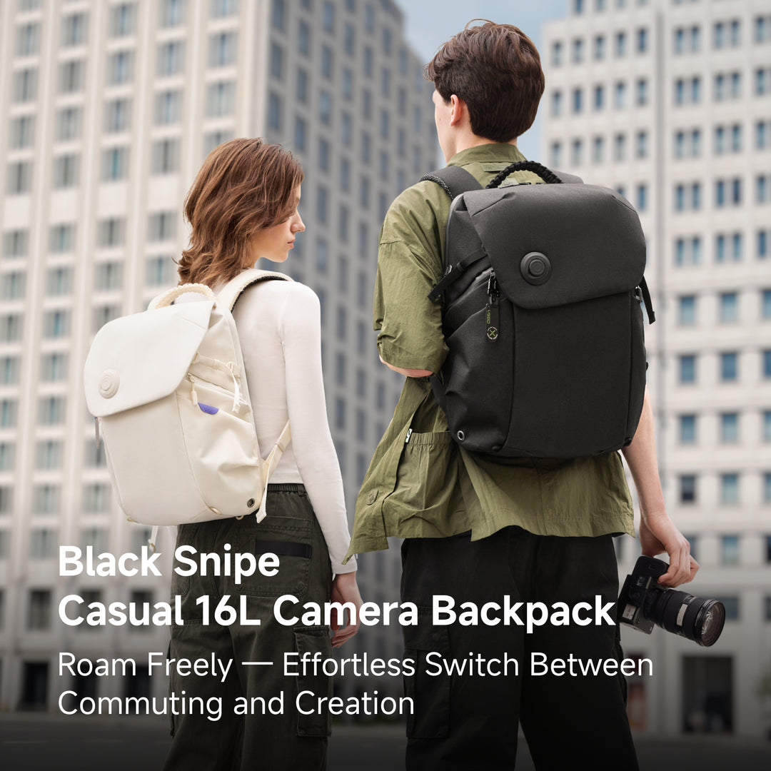 Man and women wearing VSGO Black Snipe Casual 16L Camera Backpack against a city buildings