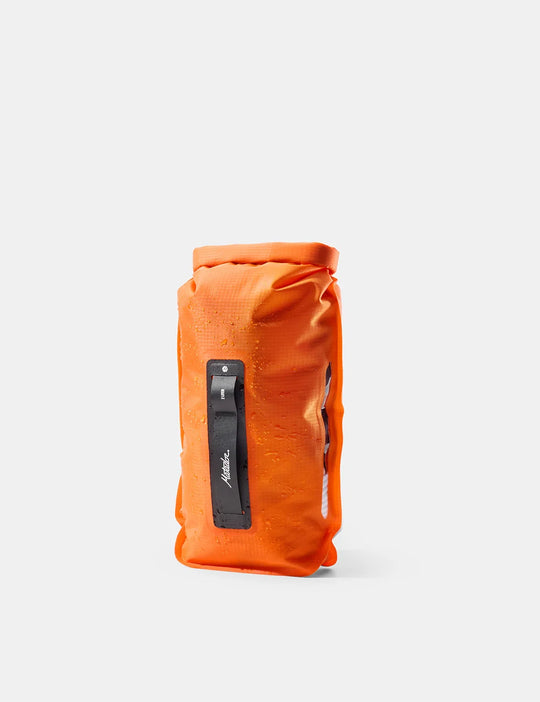 An orange waterproof roll-top bag with a black vertical strap and white &