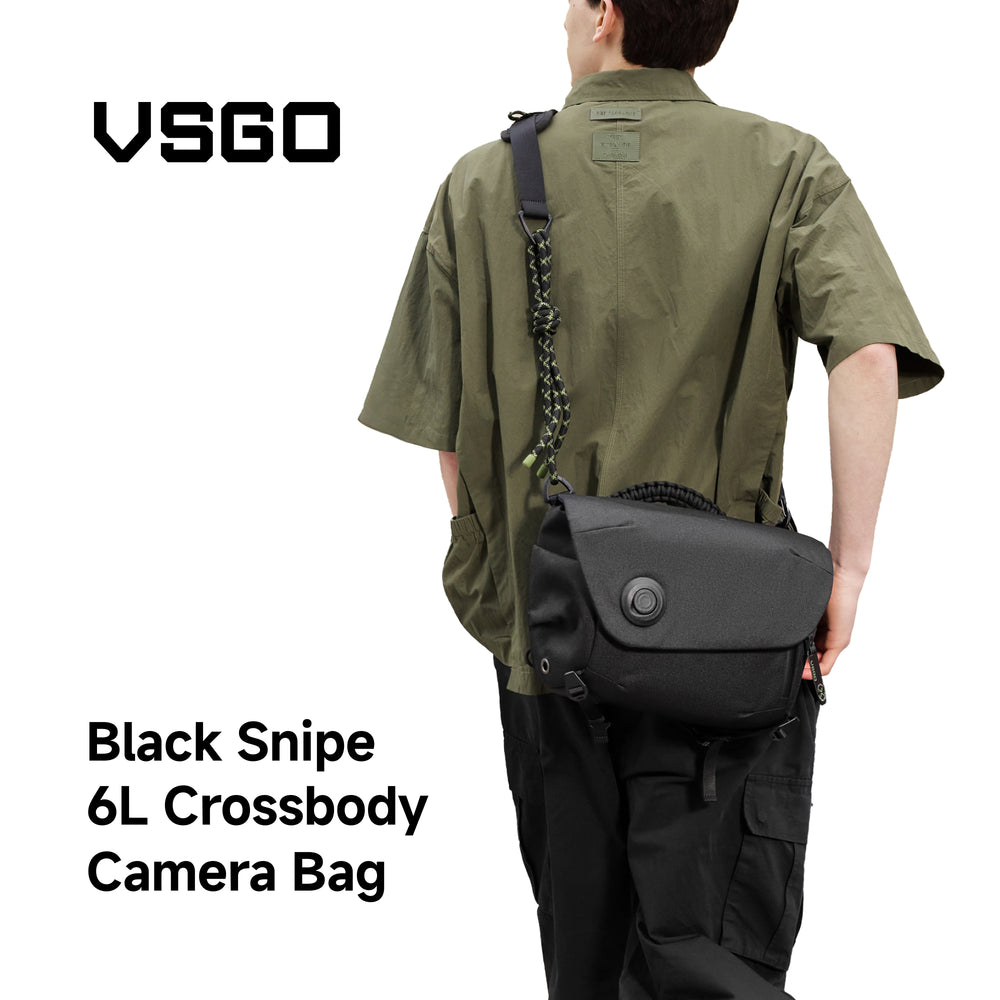 Person wearing a black crossbody camera bag with VSGO branding on a white background