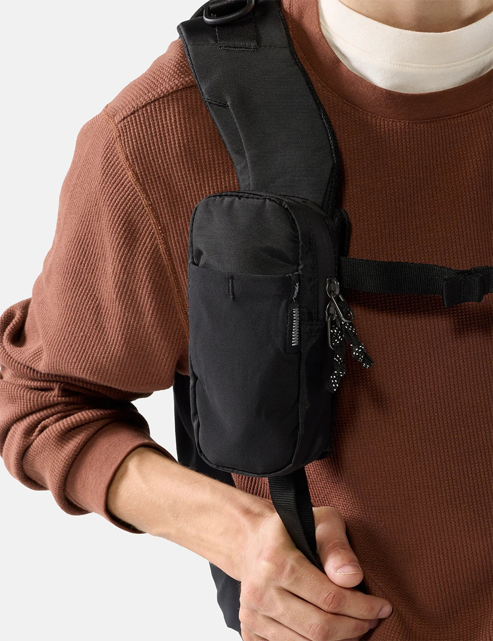 Person wearing a black matador speed stash pocket on a plain background