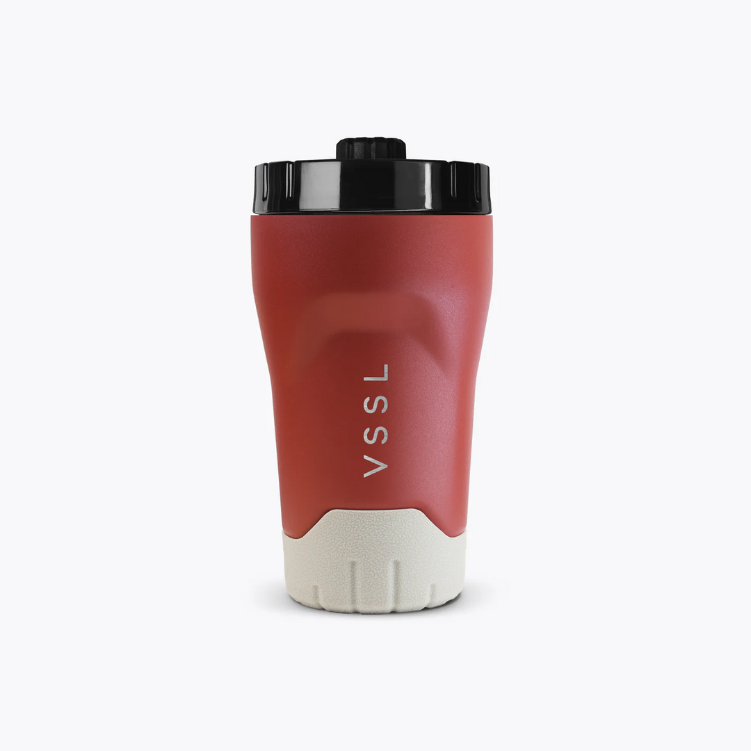 Red travel mug with black lid and white base on a white background