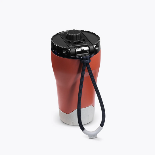 Red and gray travel mug with a black lid and handle on a white background