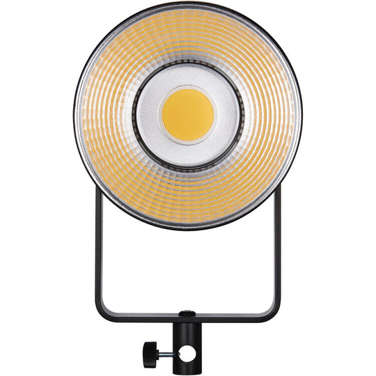 Round studio light with a black stand on a white background