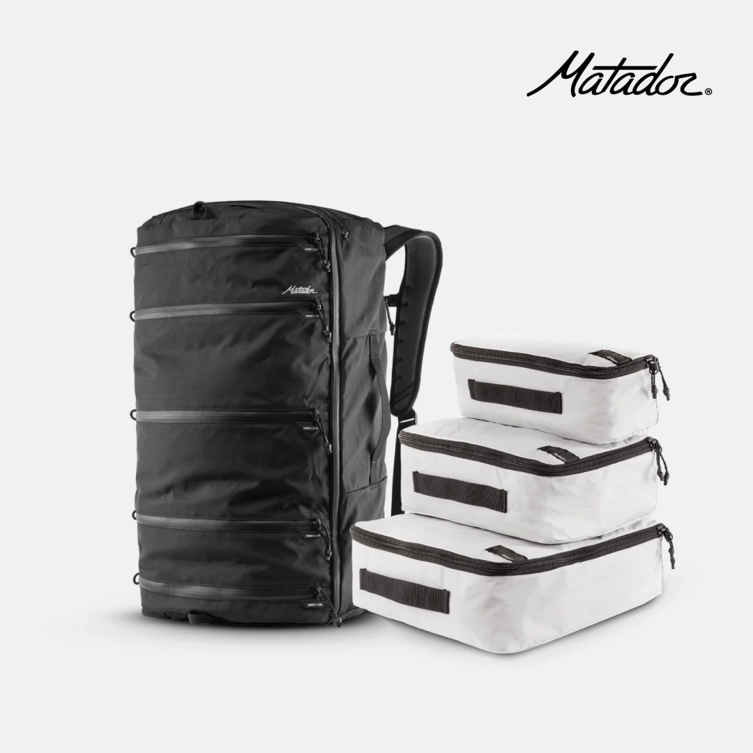 Black Matador SEG45 and white matador packing cubes on a white background