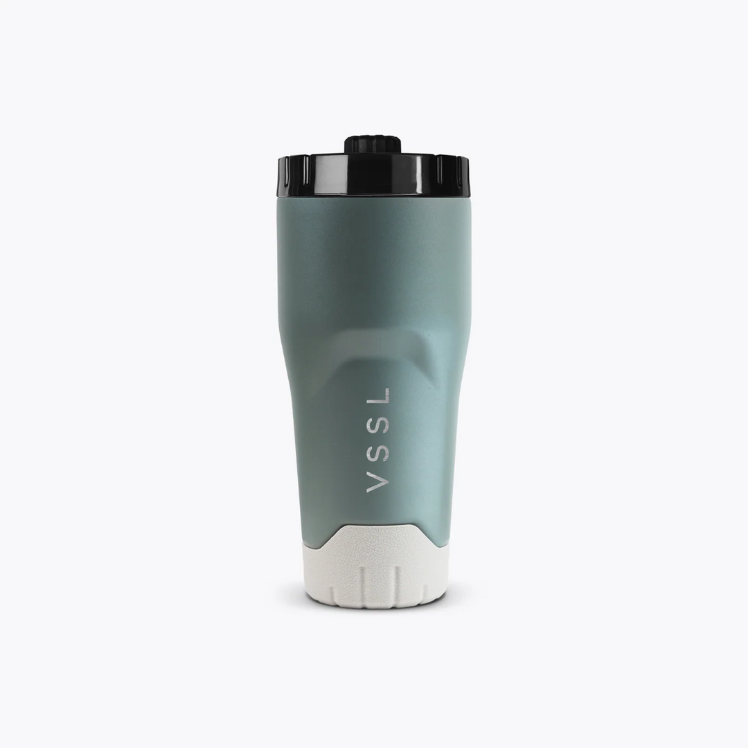 Green travel mug with black lid on a white background