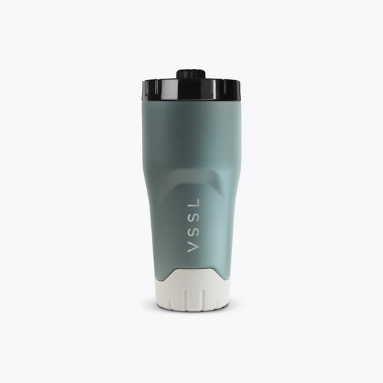 Green travel mug with black lid on a white background