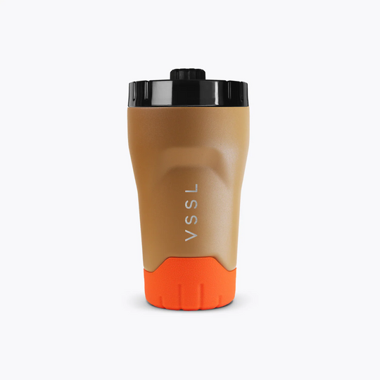 Brown and orange tumbler with black lid on a white background