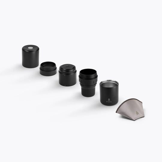 Set of black cylindrical containers with a filter on a white background