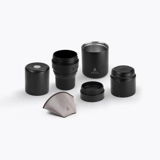 Set of black travel coffee mugs and accessories on a white background