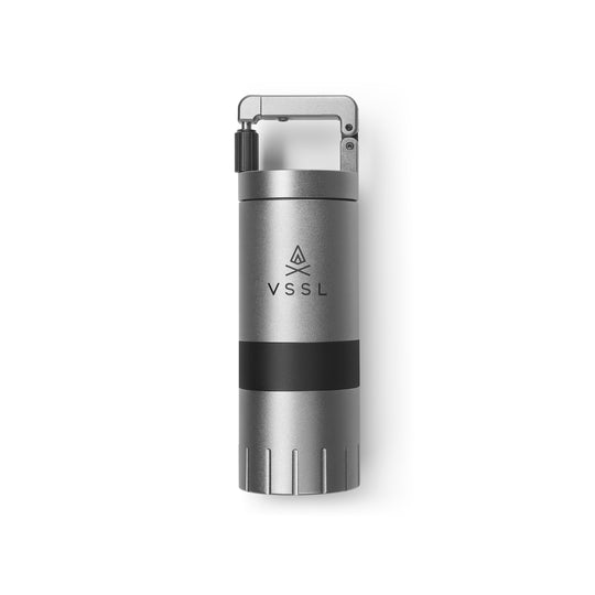 A VSSL portable water filter canister in metallic silver with a black band around the middle, shown on a clean white background.