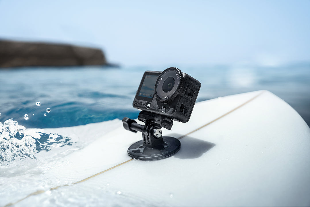 Action camera on a surfboard with ocean in the background
