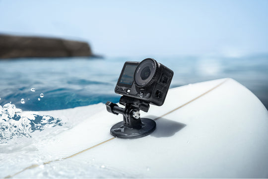 Action camera on a surfboard with ocean in the background