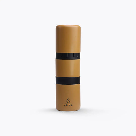Tan-colored VSSL Nest Pour Over Coffee Kit with black band and logo on a white background