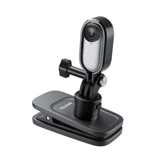 A black clip-on webcam with a silver reflective lens cover, mounted on a black adjustable stand with a spring-loaded clip base. The brand name &