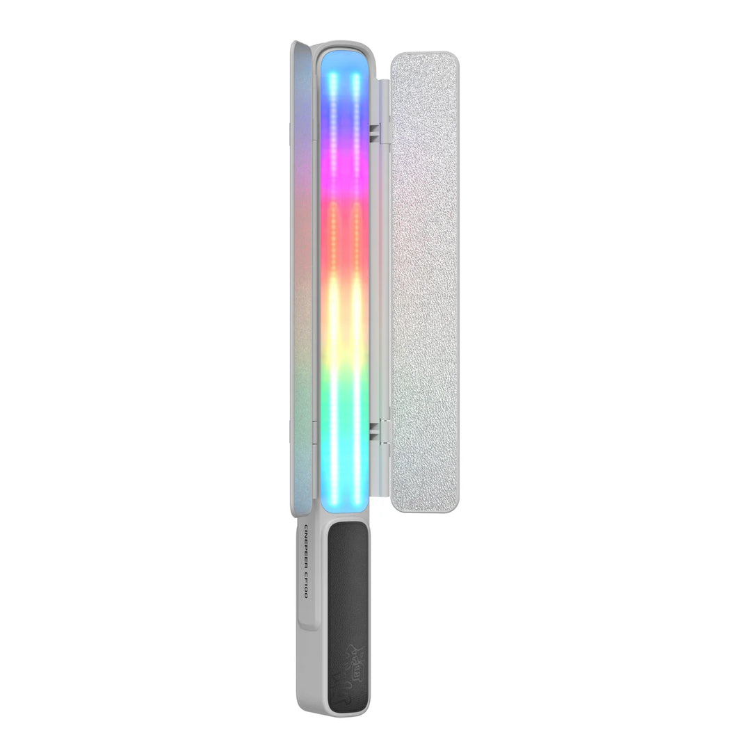 A slim rectangular LED light wand or UV light tool with a vertical rainbow light bar in blue, pink, purple, yellow, and green, shown next to a textured white panel on a white background.