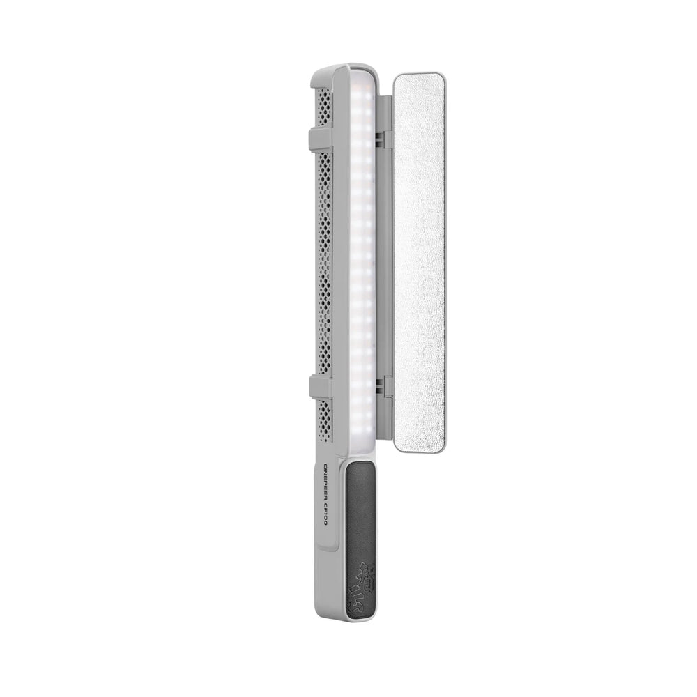 A portable LED light panel with a silver and gray body, featuring a vertical array of illuminated white LEDs, a textured silver side panel, and a dark gray power button on a solid white background.