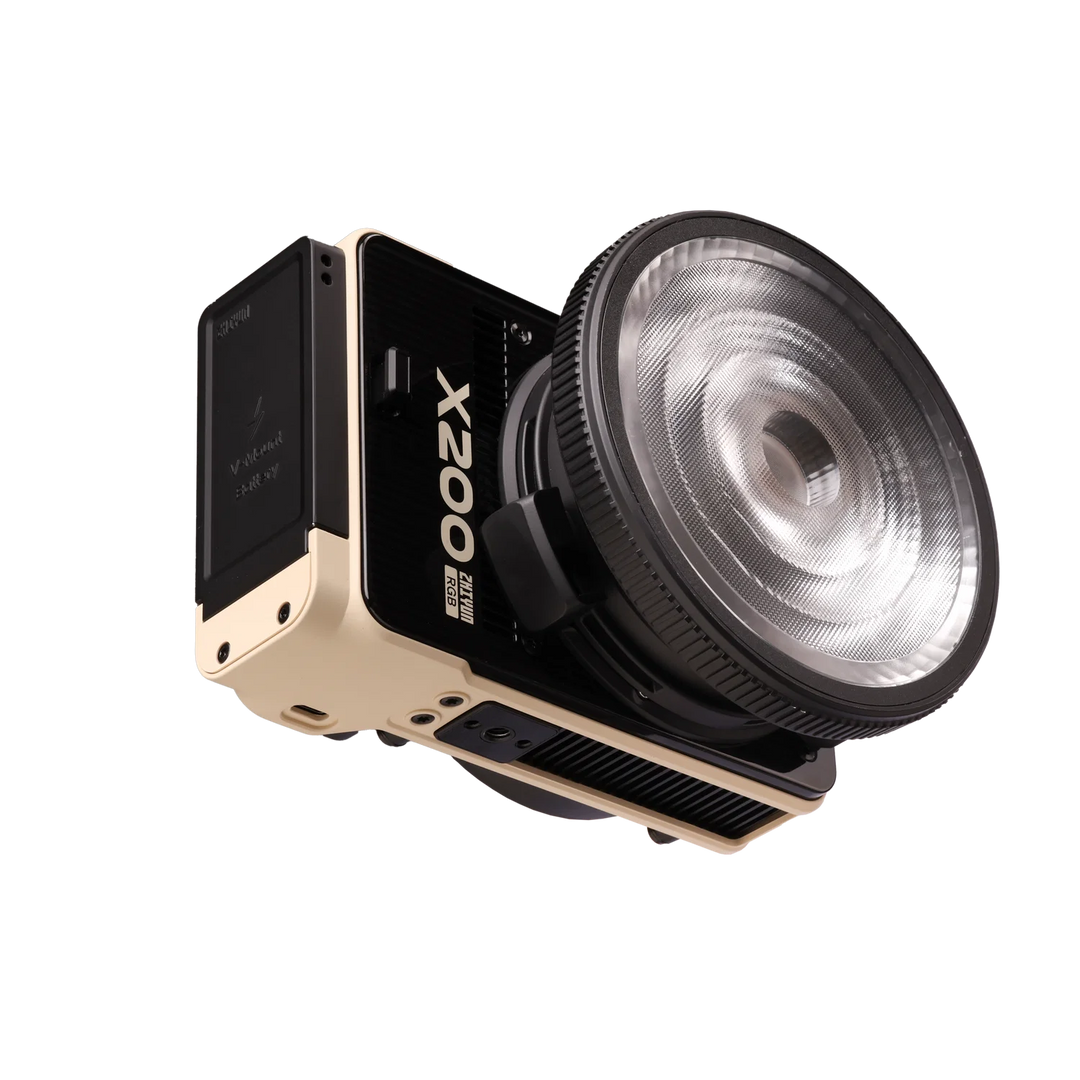 A Zhiyun X200 portable camera with a large flash attachment, featuring a black body with a beige frame and a clear textured flash lens, shown on a solid white background.