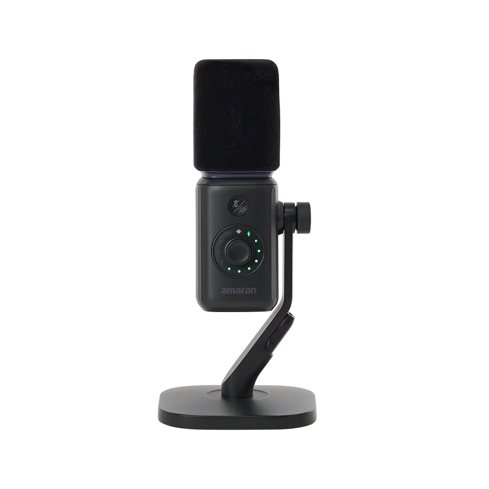 Direct front view of the black amaran Mic Desktop Stand Kit showing the foam windscreen, mute button, gain adjustment dial with LED indicator lights, and desktop stand against a transparent background.