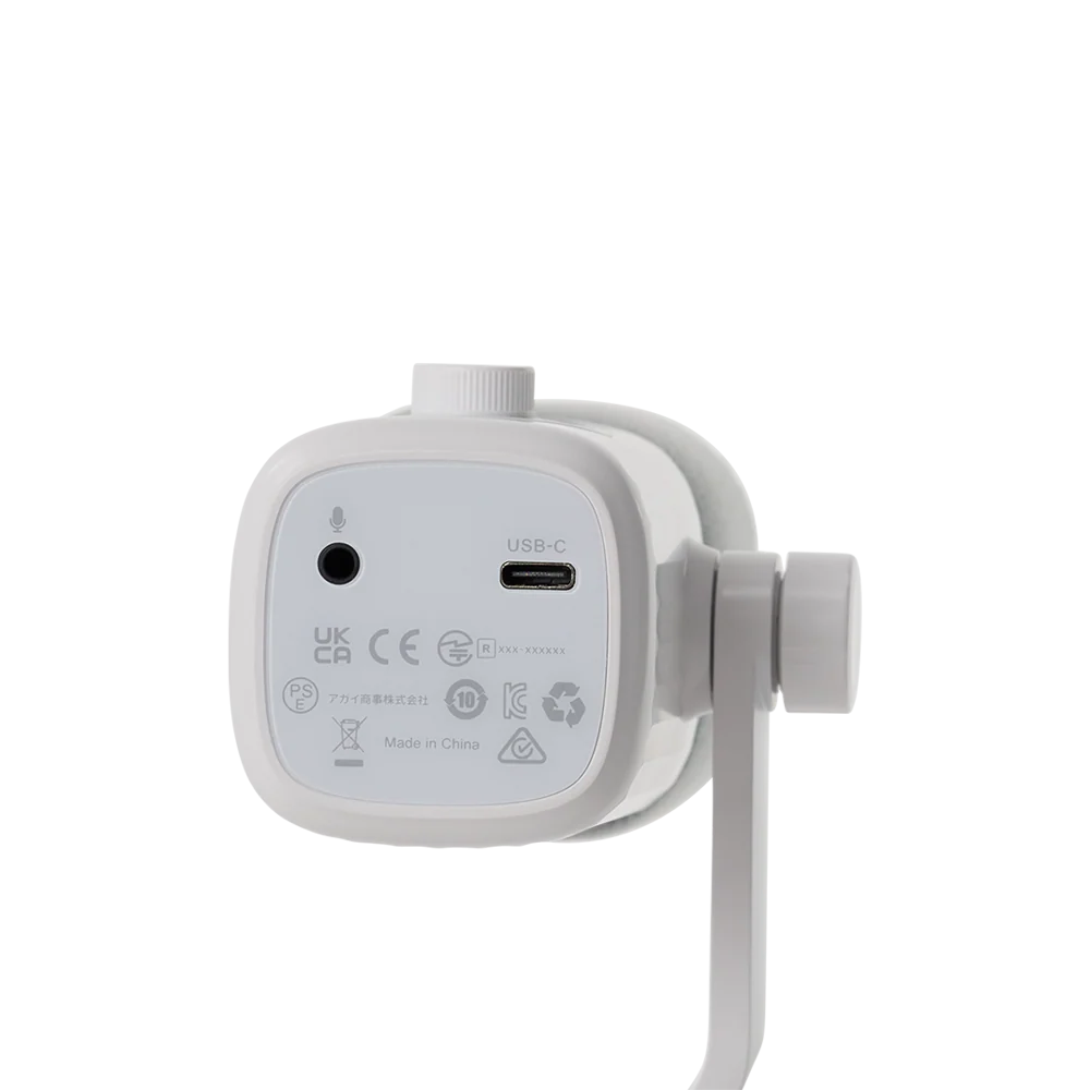Bottom panel view of the white amaran Mic Desktop Stand Kit showing the 3.5mm headphone audio jack, USB-C interface port, and regulatory labels against a transparent background.