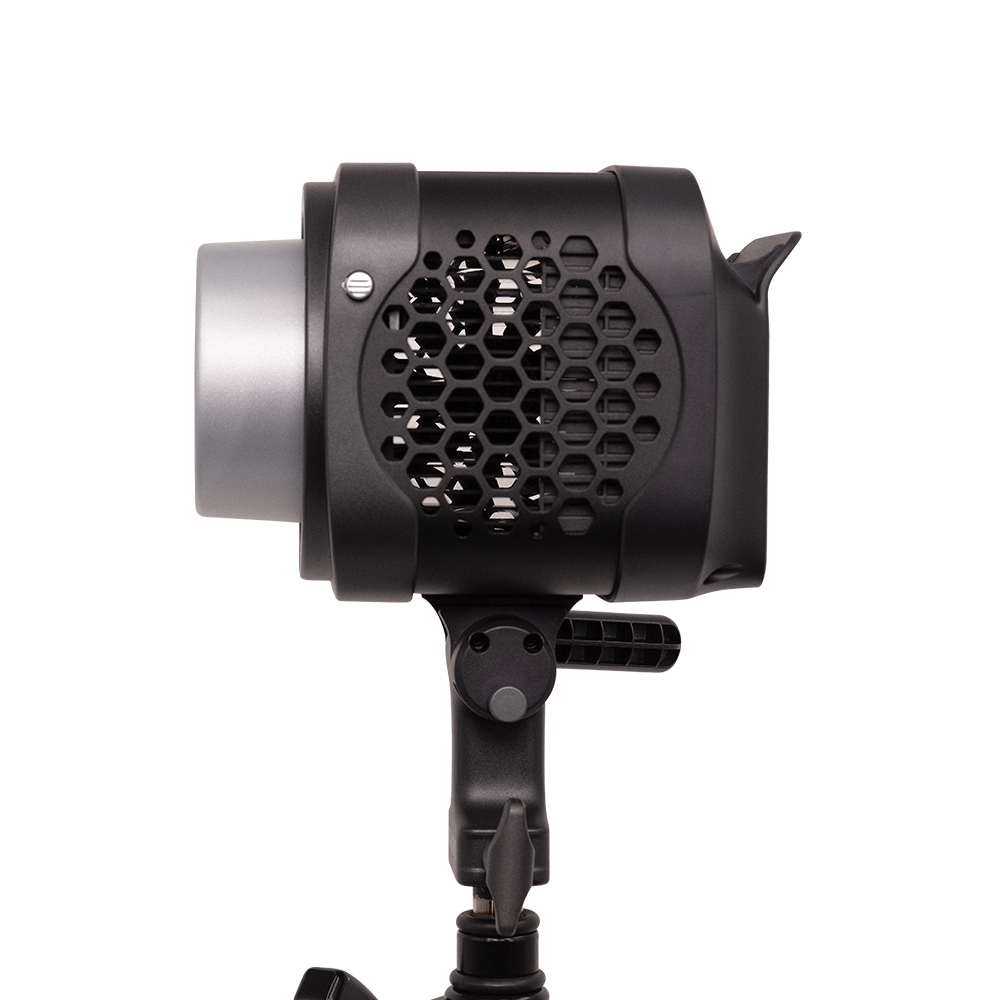 Black studio light with honeycomb grid on a white background