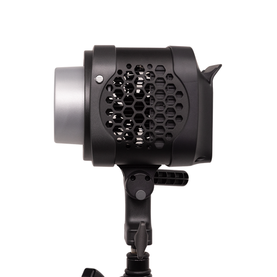 Black studio light with honeycomb grid on a white background