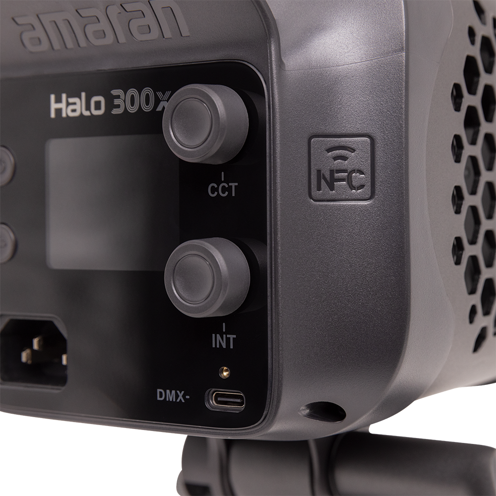 Close-up of a professional light fixture with control panel and 'amaran' branding.