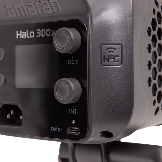 Close-up of a professional light fixture with control panel and 'amaran' branding.