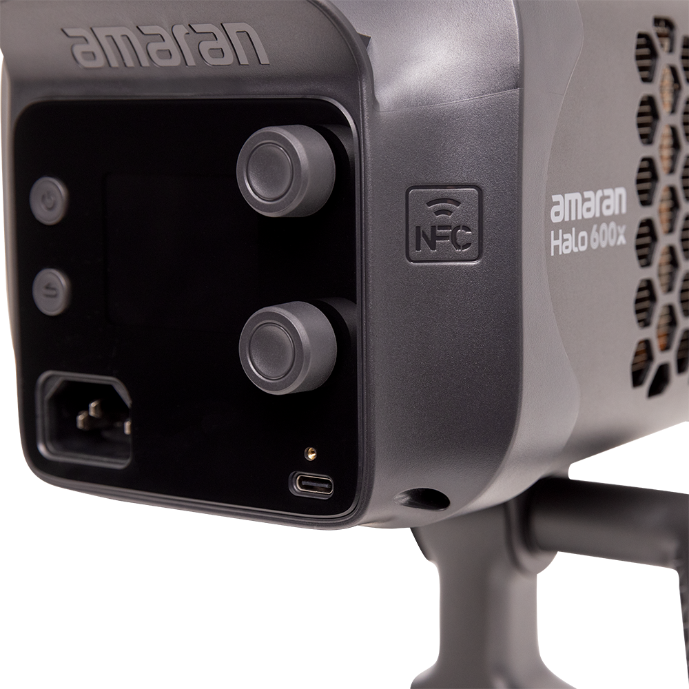 Close-up of a lighting device with 'amaran' branding on a white background