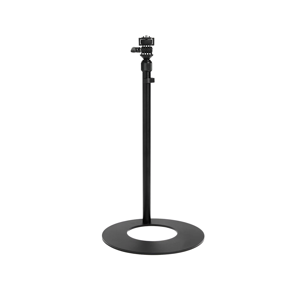amaran Desk Stand with a circular base and adjustable height, featuring a mounting bracket at the top, shown against a plain white background.