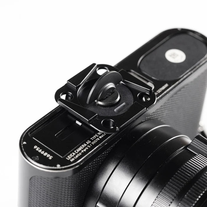 Close-up of a camera with a lens cap on a white background